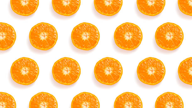 istock Pattern of cut tangerines on a white background 1472826547