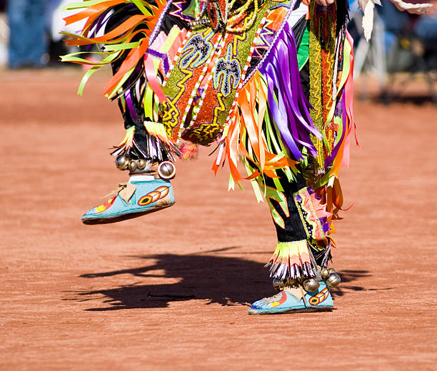 Colorful costume on the lower half of a pow wow dancer Native American dancers in traditonal rigalia perform during a Pow Wow. american tribal culture stock pictures, royalty-free photos & images