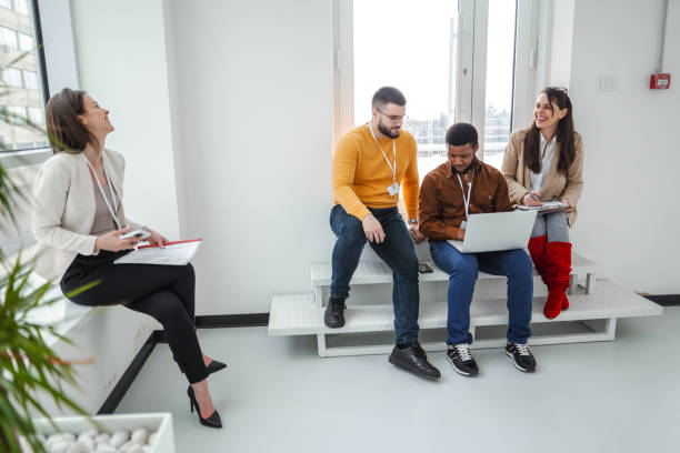 istock Business colleagues hanging out by the office window during break 1472828045