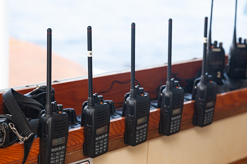 Lots of walkie-talkies attached on the windowsill, close-up.