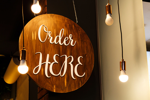 Restaurant service sign Order Here in modern loft style. Can be used in coffee shops, cafes, fast food restaurants