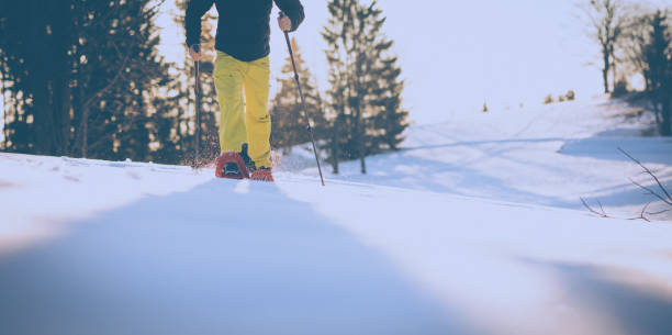 istock Snowshoeing in winter in deep snow. Walking in the snow 1472832064