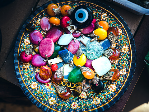 Collection of gems and precious stones stored in a ceramic bowl