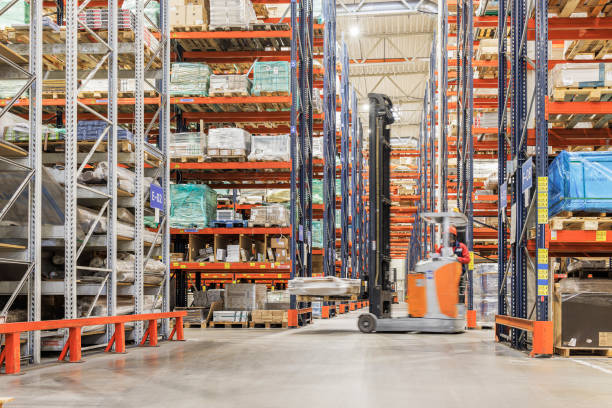 istock Forklift carrying cardboard box in warehouse. Blurred motion effect. 1472835307