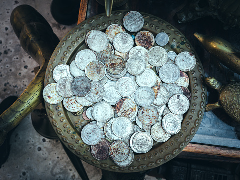 Heap of coins on display at a street market