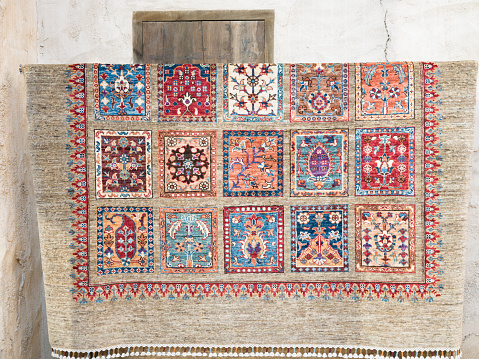 Wide image of carpet on display for sale at a souk