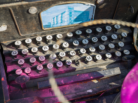 close up of the keyboard of an antique cash register, on retail display for sale at a junkyard, Long Island, New York
