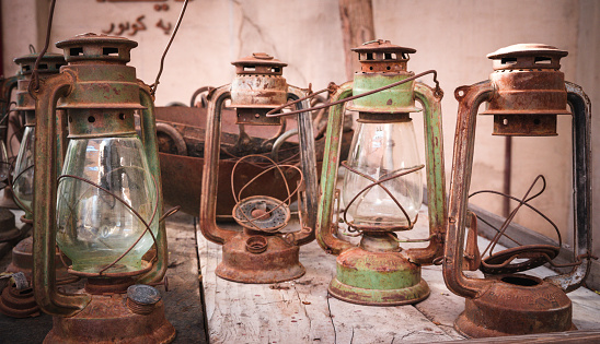 Wide image of old lantern collection on display at a store