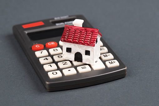 House model and calculator on black background