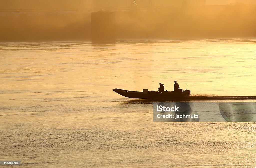 Boaters sobre el río al atardecer - Foto de stock de Río Misisipí libre de derechos