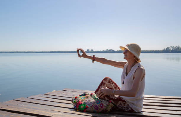 istock woman on a pier with mobile phone 1472838030