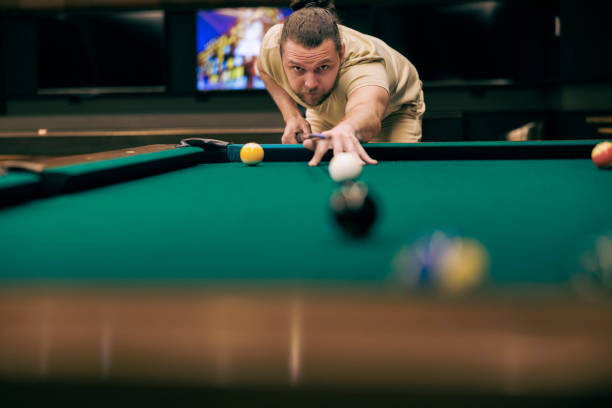 istock An amateur billiard player, practicing direct shots. 1472839620