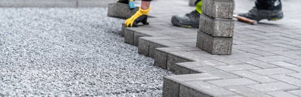 istock laying interlocking pavers during the construction of sidewalks and roads. banner with copy space 1472842682