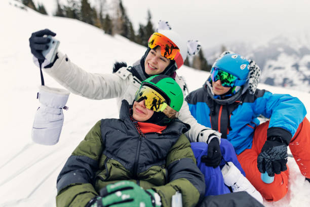 istock Three teenagers enjoy a break in skiing - resting and drinking tea. 1472844969