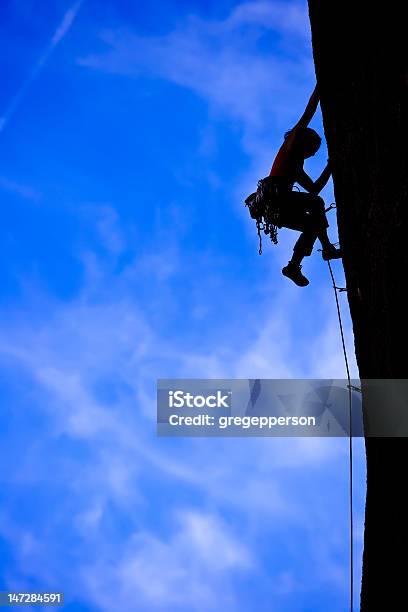 Rock Climber Clinging To A Cliff Stock Photo - Download Image Now - Challenge, Conquering Adversity, Achievement