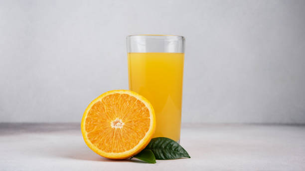 istock Fresh orange juice in glass with sliced orange fruit 1472845963