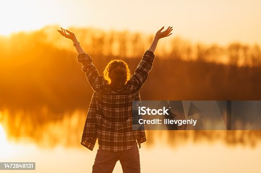 istock Curly woman on sunset background. Silhouette 1472848131