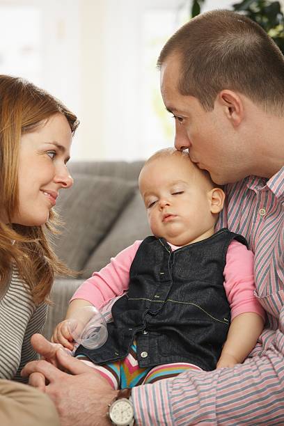 istock Baby sleeping in father's arm 147284824