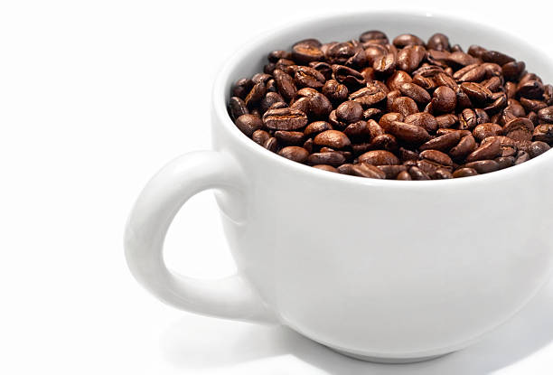 Simple White Mug Filled With Coffee Beans stock photo