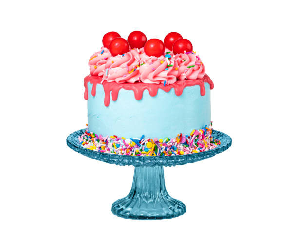 Birthday Drip Cake on a stand with red ganache isolated on white Birthday Drip Cake on a stand with red ganache, colorful sprinkles and cherry balls isolated on a pure white background. Fun, trendy and a bit retro. cake stock pictures, royalty-free photos & images