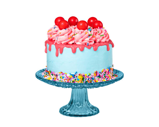 birthday drip cake on a stand with red ganache isolated on white - copy space single object confetti nobody imagens e fotografias de stock