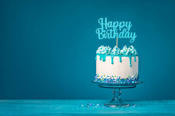 istock White happy birthday drip cake with teal ganache over blue background 1472849570