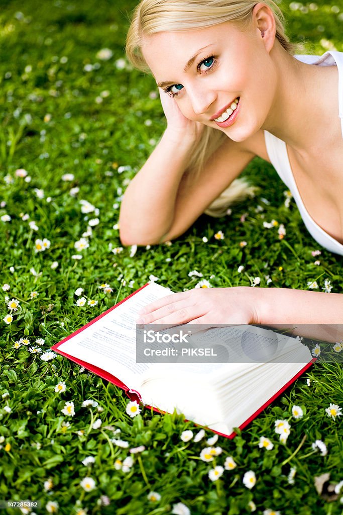 Woman lying on grass, reading book http://www.edkafelek.com/peopleoutdoors.jpg Adult Stock Photo