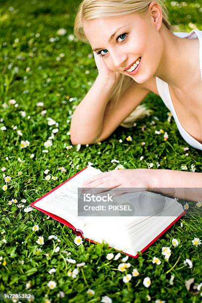 Woman Lying On Grass Reading Book Stock Photo - Download Image Now - Adult, Adults Only, Agricultural Field