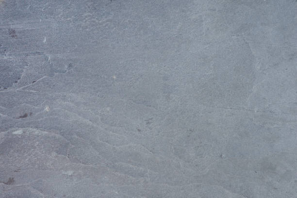 istock Texture of natural stone. Natural stone surface for flooring or wall decoration. Samples of gray stone with a wavy pattern for the interior 1472854890