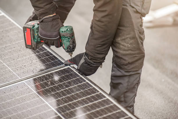istock The solar panel installer twists the modules together using aluminum fasteners and a cordless drill. Rooftop installation work and security, concept with copy space 1472854920