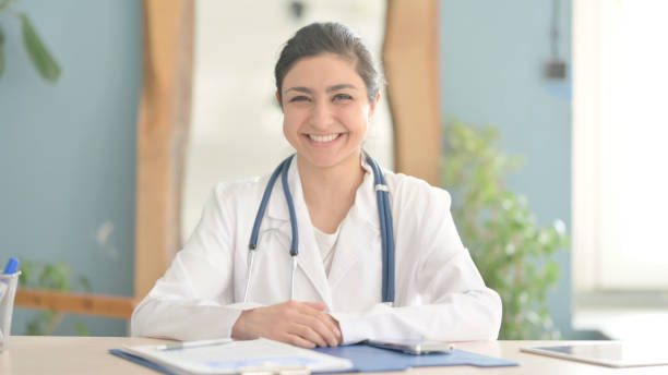 istock Smiling Young Indian Doctor in Clinic 1472858981