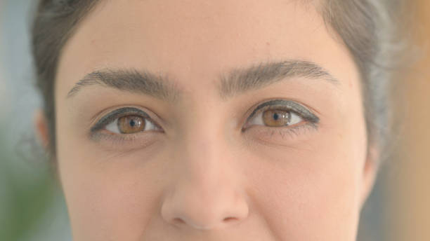 istock Close Up of Blinking Female Eyes 1472859041
