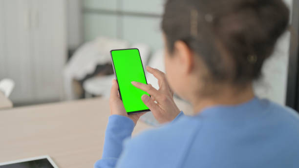 istock Indian Woman using Smartphone with Chroma Key Screen 1472859294