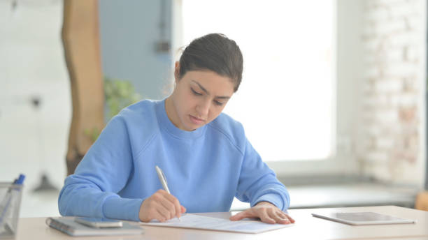 istock Indian Woman Working on Documents, Calculating Business Data 1472859415
