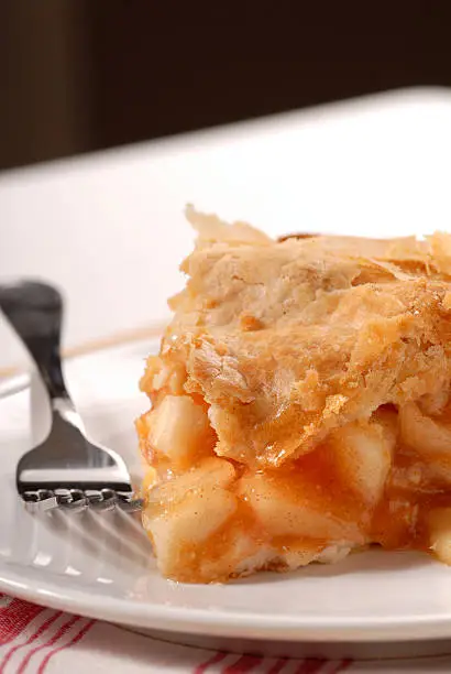 Slice of a freshly made deep dish apple pie