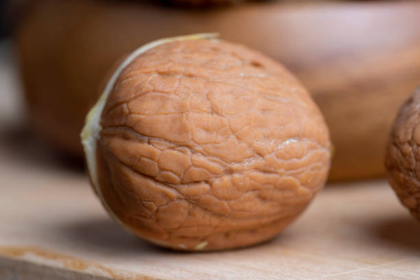 Walnuts in a row on dark walnut table background