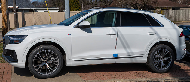 Sewickley, Pennsylvania, USA March 5, 2023 A new, white Audi SUV for sale at a dealership on a sunny winter day