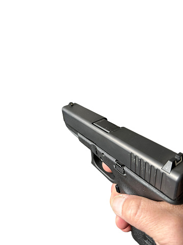 Hand holding handgun isolated on white background