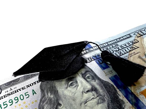Hundred dollar bill with graduation gown stock photo