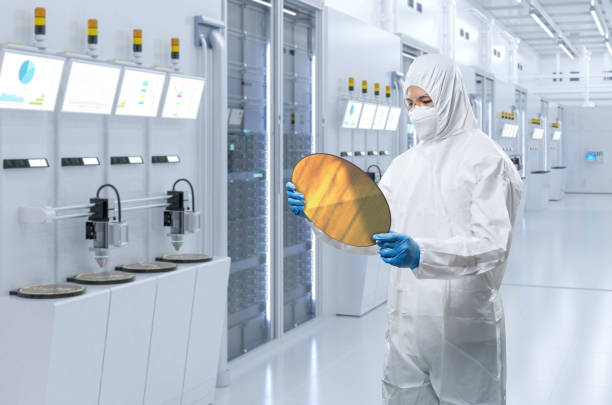 Worker or engineer wears medical protective suit or white coverall suit with silicon wafer