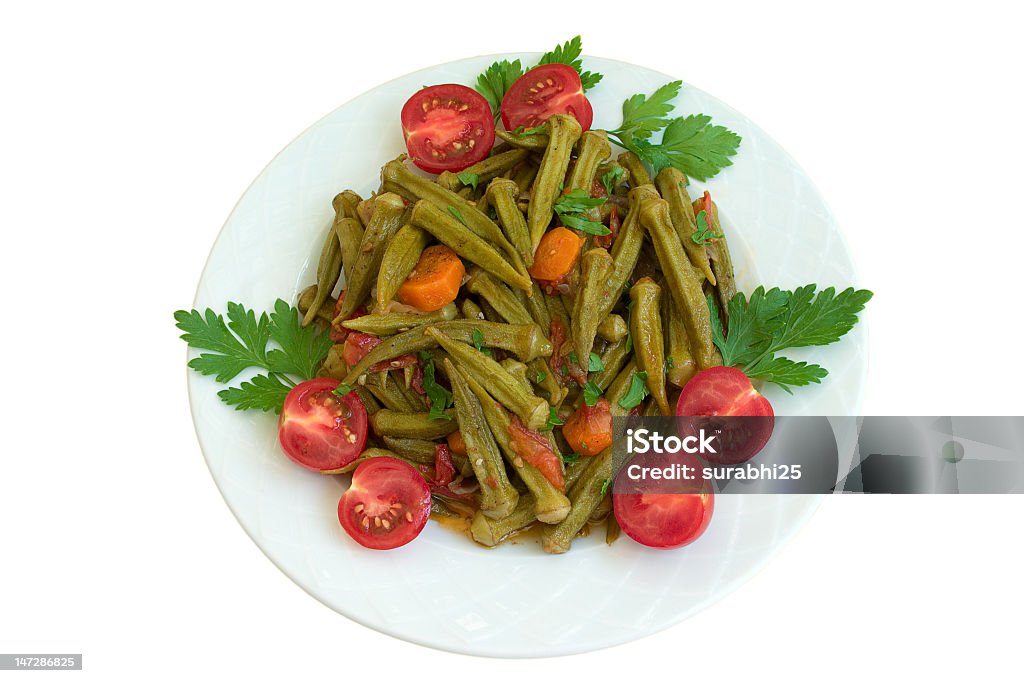 okra, gumbo okra with tomatoes, carrot and parsley on plate isolated on white background Okra Stock Photo