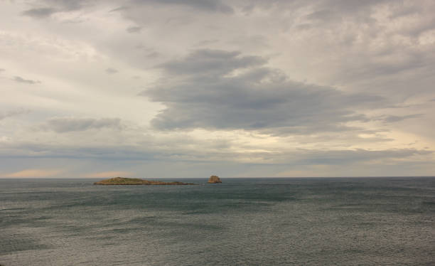 istock grey clouds over the horizon in the sea 1472870349