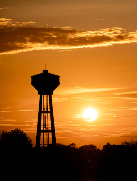 istock Background silhouette of water Storage tanks (Champagne tower) backlit in the evening sunlight. 1472874176