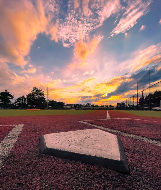 Home plate Sunset at the ball field baseball diamond stock pictures, royalty-free photos & images