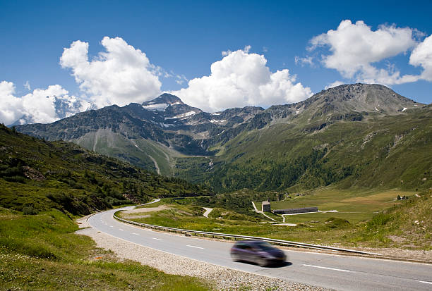 Road leading out of valley in Swiss Alps stock photo