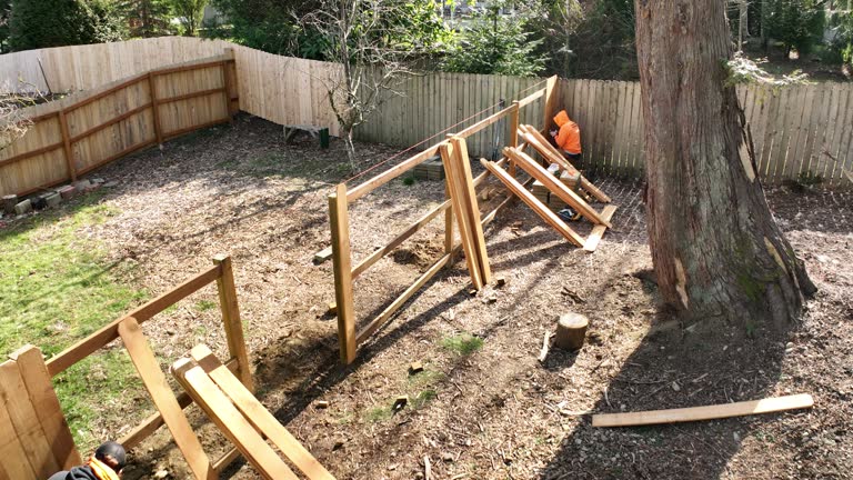 Aerial View of Fence Being Built By Two Workers in a Suburban Backyard