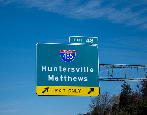 Highway I-485 exit sign in Charlotte, NC. Exit 48 Huntersville Mathews.
