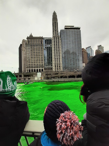 Spectators enjoying the view of the newly dyed green Chicago River for St. Patrick's Day, a tradition.