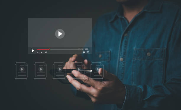 istock Selective focus at finger that push on press play button for start online entertainment for on demand video streaming service that online over internet which include movie or music. 1472895272