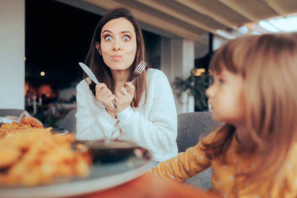 istock Funny Hungry Mom Holding Knife and Fork 1472895445